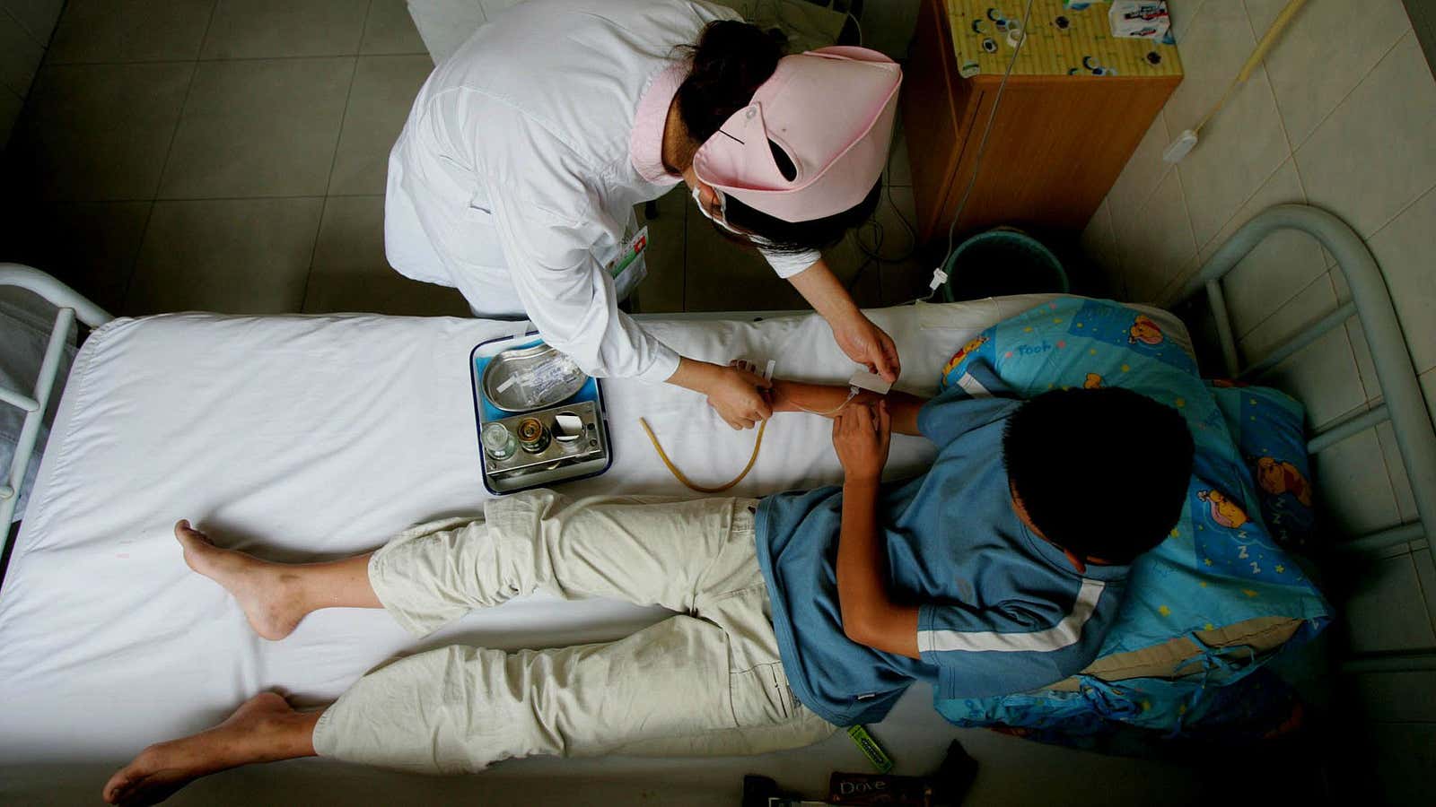 A nurse cares for a boy who spent three straight days in an internet cafe in Beijing.
