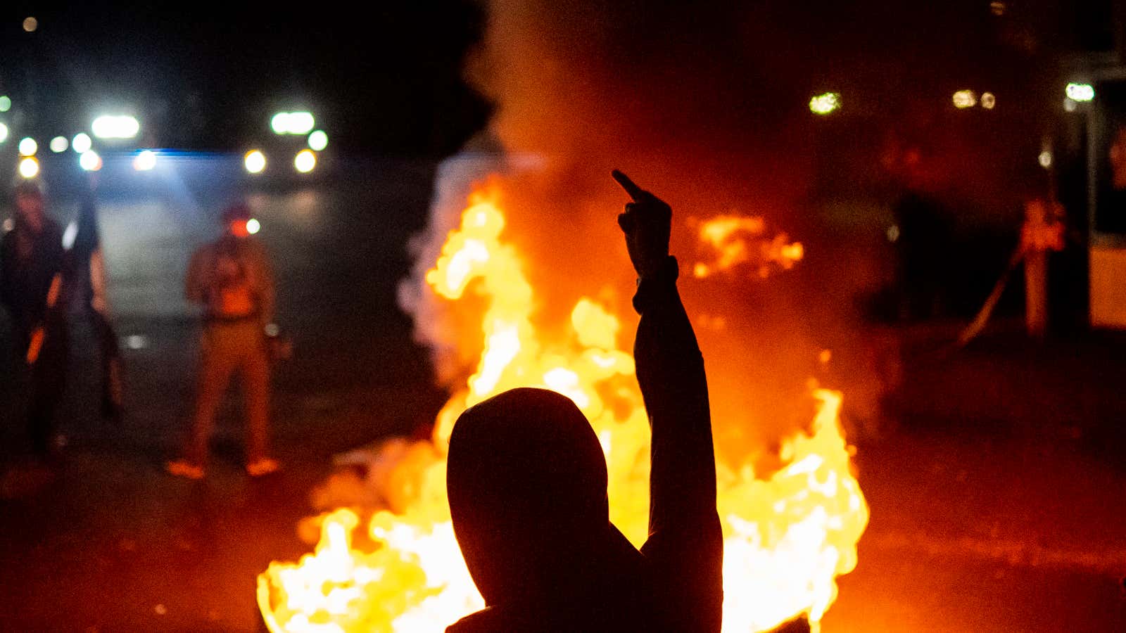 Protesters chant in front of a fire near the North police precinct during a protest against racial injustice and police brutality on September 6, 2020 in Portland, Oregon. 
