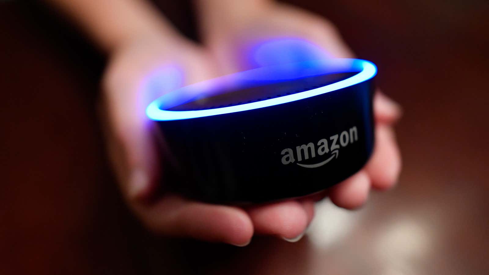 In this Aug. 16, 2018, file photo a child holds his Amazon Echo Dot in Kennesaw, Ga. Amazon met with skepticism from some privacy advocates and members of Congress last year when it introduced its first kid-oriented voice assistant , along with brightly colored models of its Echo Dot speaker designed for children.