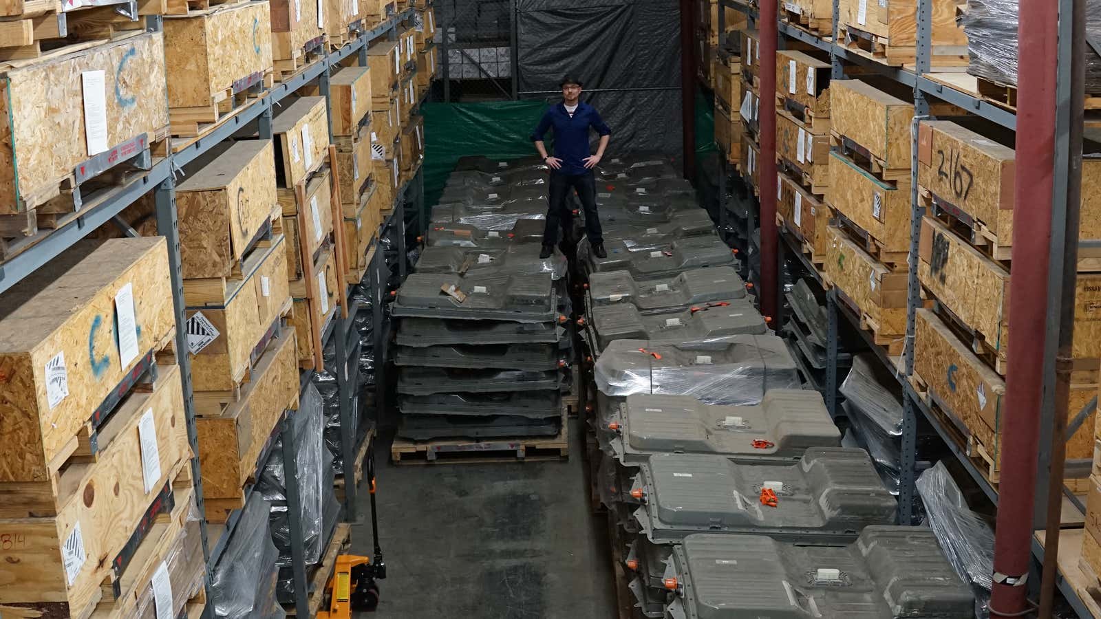 Eric Lundgren standing on 4.7 Megawatts of Nissan Leaf battery packs at BigBattery Inc.&#39;s Chatsworth facility.