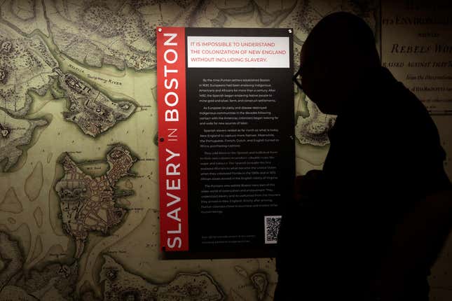 Boston, MA - June 13: A man reads a panel in the “Slavery in Boston” exhibit at Faneuil Hall.