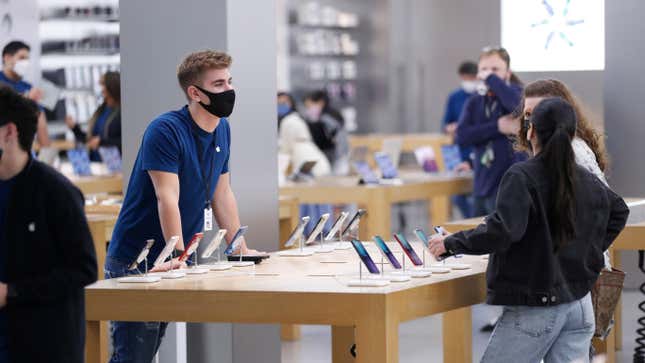 An Apple store employee wearing a mask at a store in Tampa, Florida on Black Friday on Nov. 26, 2021.