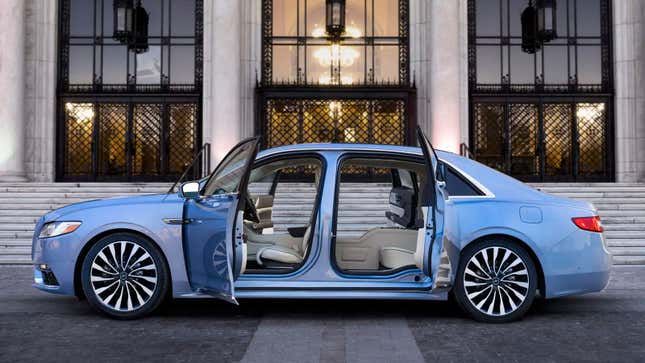 A pale blue Lincoln Continental with its suicide doors open