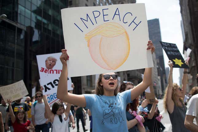 Demonstrators march across Fifth Avenue.