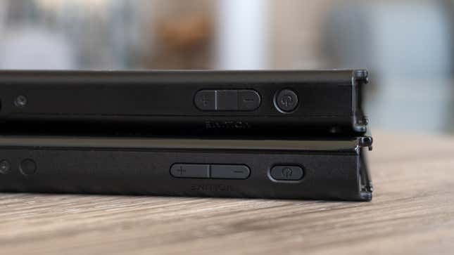 The power and volume buttons on the new Switch OLED (bottom) are slightly longer than those on the original Switch (top).
