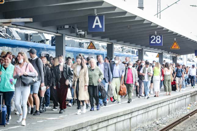 People arrive on a train platform at Hauptbahnhof railway station during the Pentecost long weekend on June 4, 2022 in Munich, Germany. Germany, in an effort to dissuade people from traveling by car and to provide relief from the current high level of inflation, introduced a 9 Euro monthly railway ticket on June 1 that covers local and regional travel nationwide. 
