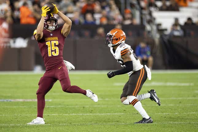 Aug 11, 2023; Cleveland, Ohio, USA; Washington Commanders wide receiver Dax Milne (15) makes a reception under coverage by Cleveland Browns cornerback Cameron Mitchell (29) during the third quarter at Cleveland Browns Stadium.