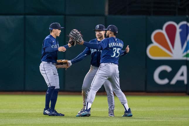 May 2, 2023; Oakland, California, USA;  Seattle Mariners center fielder Jarred Kelenic (10), right fielder Teoscar Hernandez (35) and Seattle Mariners left fielder Sam Haggerty (0) celebrate after defeating the Oakland Athletics at RingCentral Coliseum.