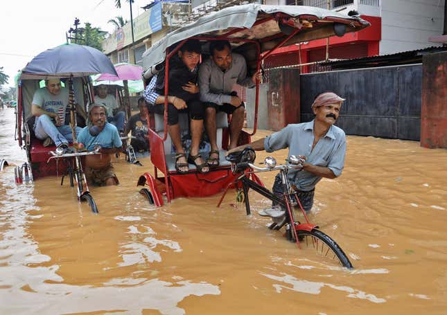 Rickshaw pullers in Guwahati's floods