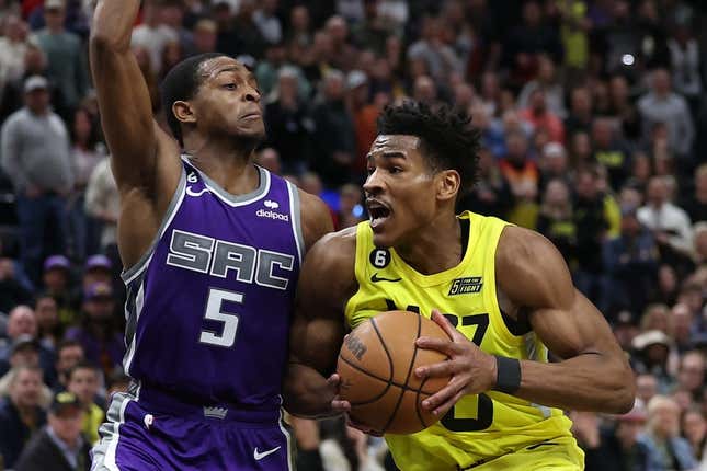 Mar 20, 2023; Salt Lake City, Utah, USA; Utah Jazz guard Ochai Agbaji (30) drives against Sacramento Kings guard De'Aaron Fox (5) in the fourth quarter at Vivint Arena.