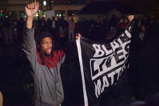 Black man holding BLM flag 