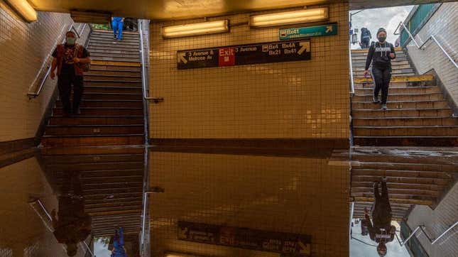  Commuters walk into a flooded 3rd Avenue / 149th St subway station after heavy rainfall from the remnants of Hurricane Ida on September 2, 2021, in New York City.