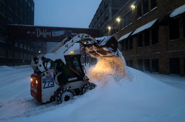A worker with RJM Construction clears snow from a work site on February 23, 2023 in Minneapolis, Minnesota. 