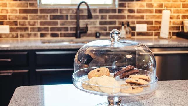 Cookies under glass dome on kitchen counter