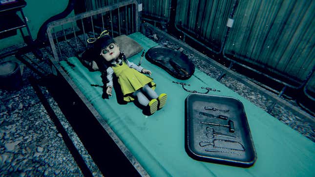 A creepy doll of a young girl lies on a hospital bed in a coldly lit environment with a tray of surgical tools nearby.