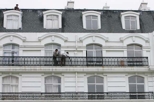 Workers fix an apartment building in Tianducheng development, China.