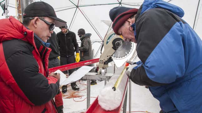 Researchers with an ice core drilled from the Guliya Ice Cap.