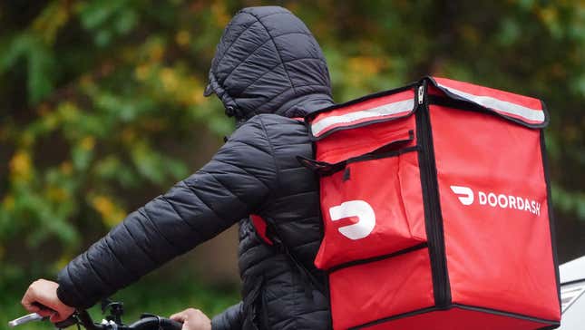 A delivery person for Doordash rides his bike in the rain in the Manhattan borough of New York City