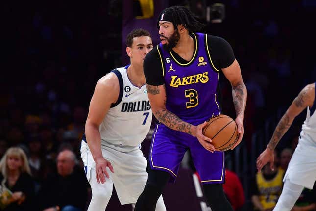Mar 17, 2023; Los Angeles, California, USA; Los Angeles Lakers forward Anthony Davis (3) controls the ball against Dallas Mavericks center Dwight Powell (7) during the first half at Crypto.com Arena.