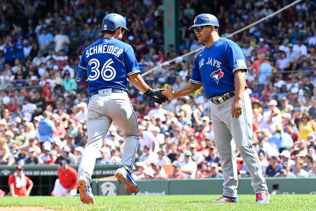 Aug 6, 2023; Boston, Massachusetts, USA; Toronto Blue Jays second baseman Davis Schneider (36) celebrates a two run home run against the Boston Red Sox with third base coach Luis Rivera (20) in the fourth inning at Fenway Park.