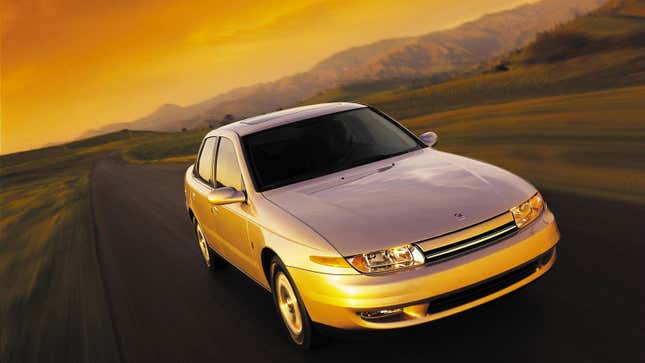 A photo of a Saturn sports car at sunset. 