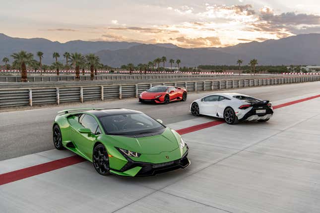 Three Huracan Tecnicas parked on the track. One green, one white and one orange.