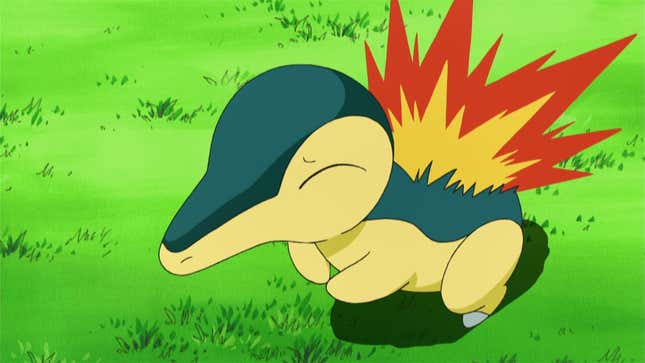 Cyndaquil is seen standing in a grassy area with a concerned look on its face.