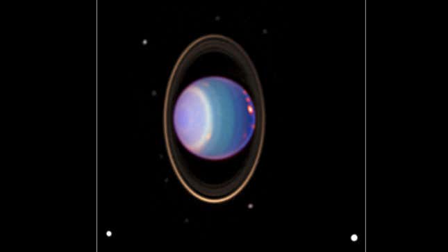 A color-added view of Uranus, 10 of its moons, and several of its rings.