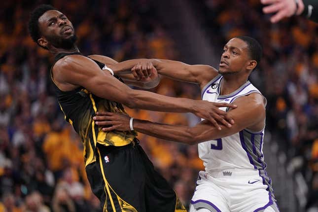 Apr 20, 2023; San Francisco, California, USA; Golden State Warriors forward Andrew Wiggins (22) is fouled by Sacramento Kings guard De&#39;Aaron Fox (5) in the second quarter during game three of the 2023 NBA playoffs at the Chase Center.
