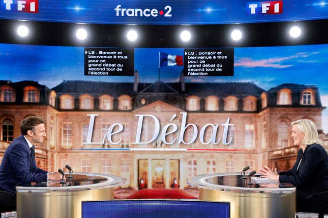 FILE PHOTO: French President Emmanuel Macron, candidate for his re-election, and French far-right Rassemblement National party presidential candidate Marine Le Pen sit prior to taking part in a French presidential election debate, in Saint-Denis, north of Paris, France April 20, 2022. Ludovic Marin/Pool via REUTERS/File Photo