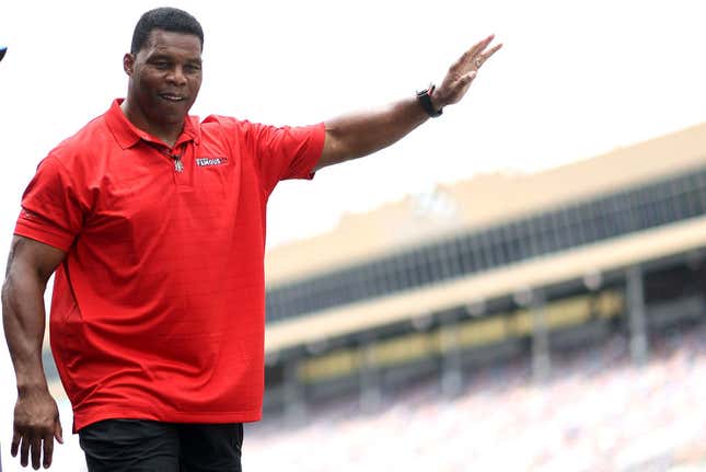  Republican candidate for US Senate Herschel Walker waves to fans as he walks onstage during pre-race ceremonies before the NASCAR Cup Series Quaker State 400 at Atlanta Motor Speedway on July 10, 2022, in Hampton, Georgia.