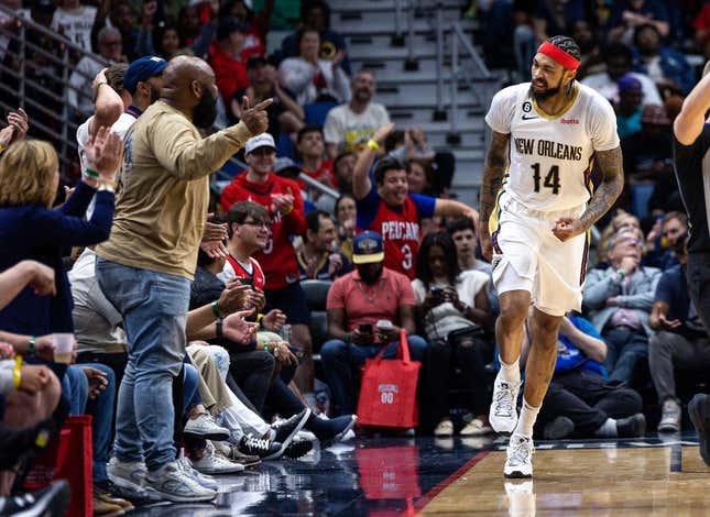 Apr 1, 2023; New Orleans, Louisiana, USA;  New Orleans Pelicans forward Brandon Ingram (14) reacts to making a basket against LA Clippers forward Kawhi Leonard (2) with a fan during the second half at Smoothie King Center.