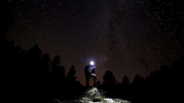 A man takes pictures at night of the annual Perseid meteor shower.