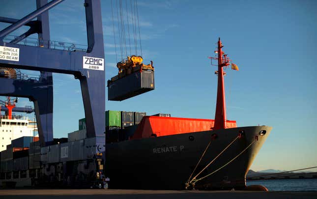 A crane loads a container on a cargo ship at the Total Terminal International Algeciras (TTIA) at the port of Algeciras, southern Spain.