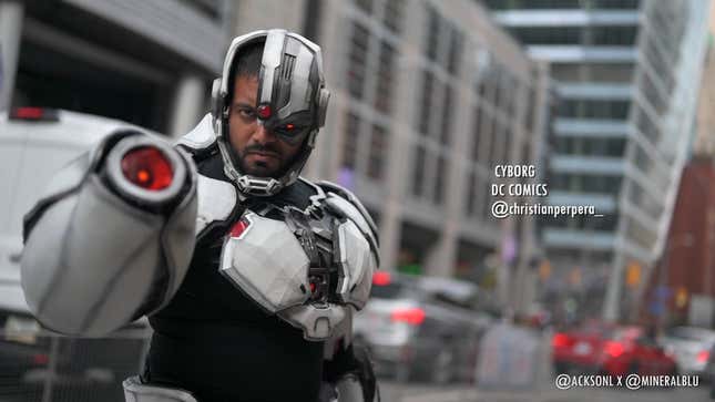 A cosplayer dressed as Cyborg from DC comics stares into the camera. 