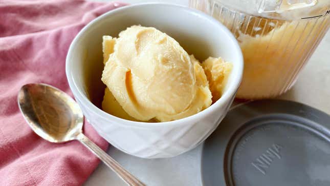 Ice cream in a bowl with Ninja Creami accessories visible around it