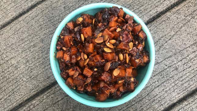 Sweet Potato Chutney in blue bowl on wooden surface