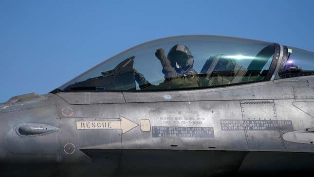 The pilot of a Greek Fighter Jet F-16 Viper salutes prior to takeoff. 