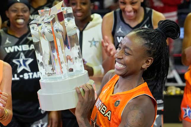 Jewell Loyd hoists a much more pleasant-looking All-Star MVP trophy.