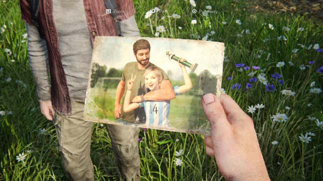 Joel holds a photograph of himself with his daughter Sarah at a soccer game from the game The Last of Us. 