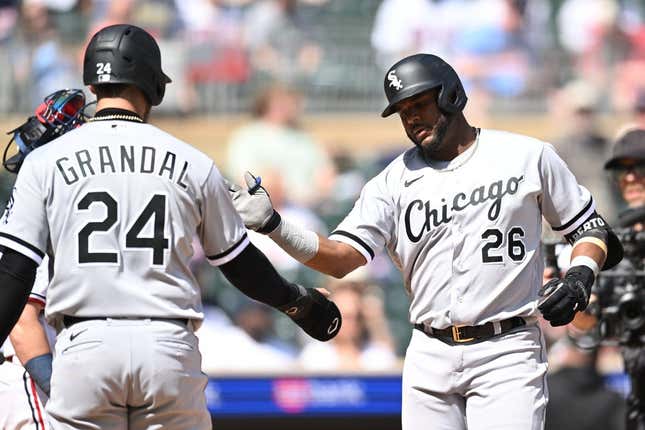 Apr 10, 2023; Minneapolis, Minnesota, USA; Chicago White Sox shortstop Hanser Alberto (26) celebrates with catcher Yasmani Grandal (24) after hitting a three run home run against Minnesota Twins starting pitcher Kenta Maeda (not pictured) during the fourth inning at Target Field.