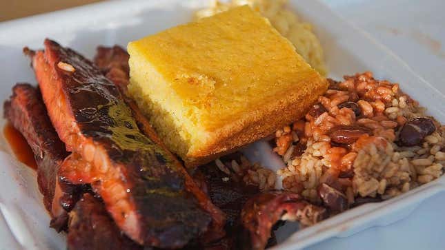 Barbecue spare ribs, red beans and rice, macaroni and cheese and cornbread in foam container