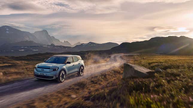 A render of the Ford Explorer EV driving on a dirt road. 