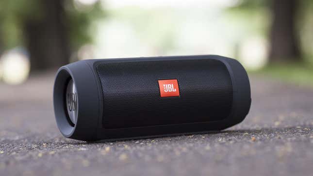 JBL Bluetooth speaker sitting outside on ground