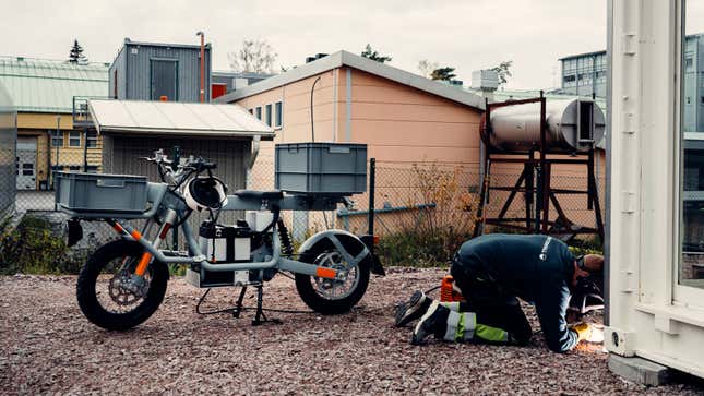 A grey Ösa :work bike parked on a building site 