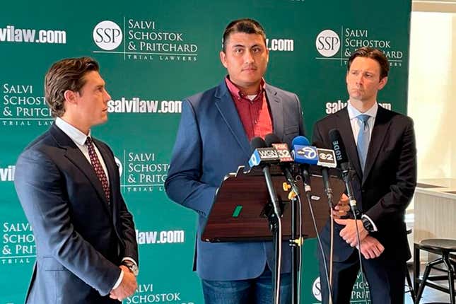 Former Northwestern University football player Ramon Diaz, flanked by attorneys Parker Stinar (l.) and Patrick Salvi, speaks during a news conference in Chicago