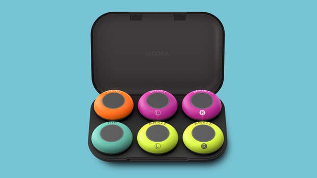 The entire collection of Sony Mocopi trackers in their charging case with its lid open.