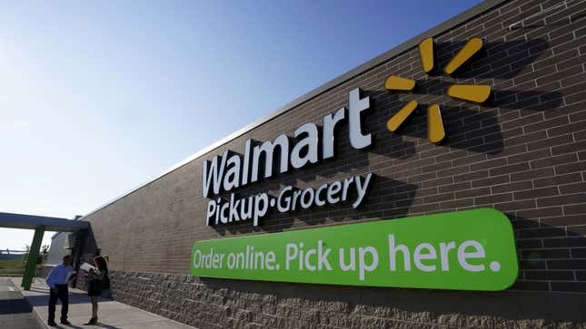 People talk outside a Wal-Mart store's grocery pickup.