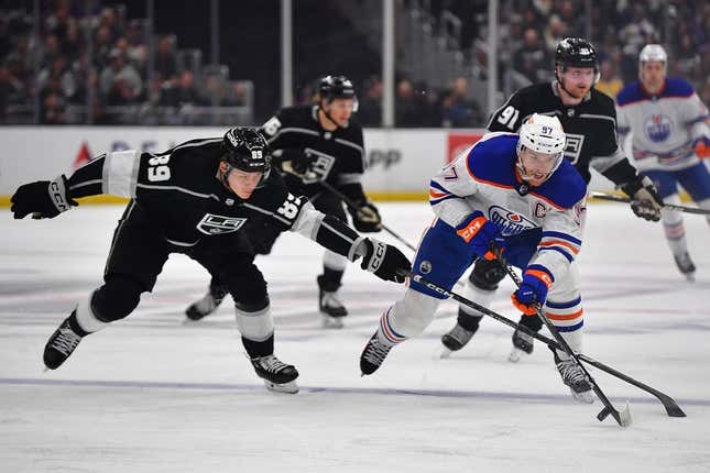 Apr 29, 2023; Los Angeles, California, USA; Edmonton Oilers center Connor McDavid (97) moves the puck against Los Angeles Kings center Rasmus Kupari (89) during the first period in game six of the first round of the 2023 Stanley Cup Playoffs at Crypto.com Arena.