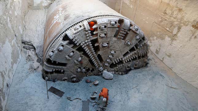 A photo of a boring machine digging a tunnel through rock. 